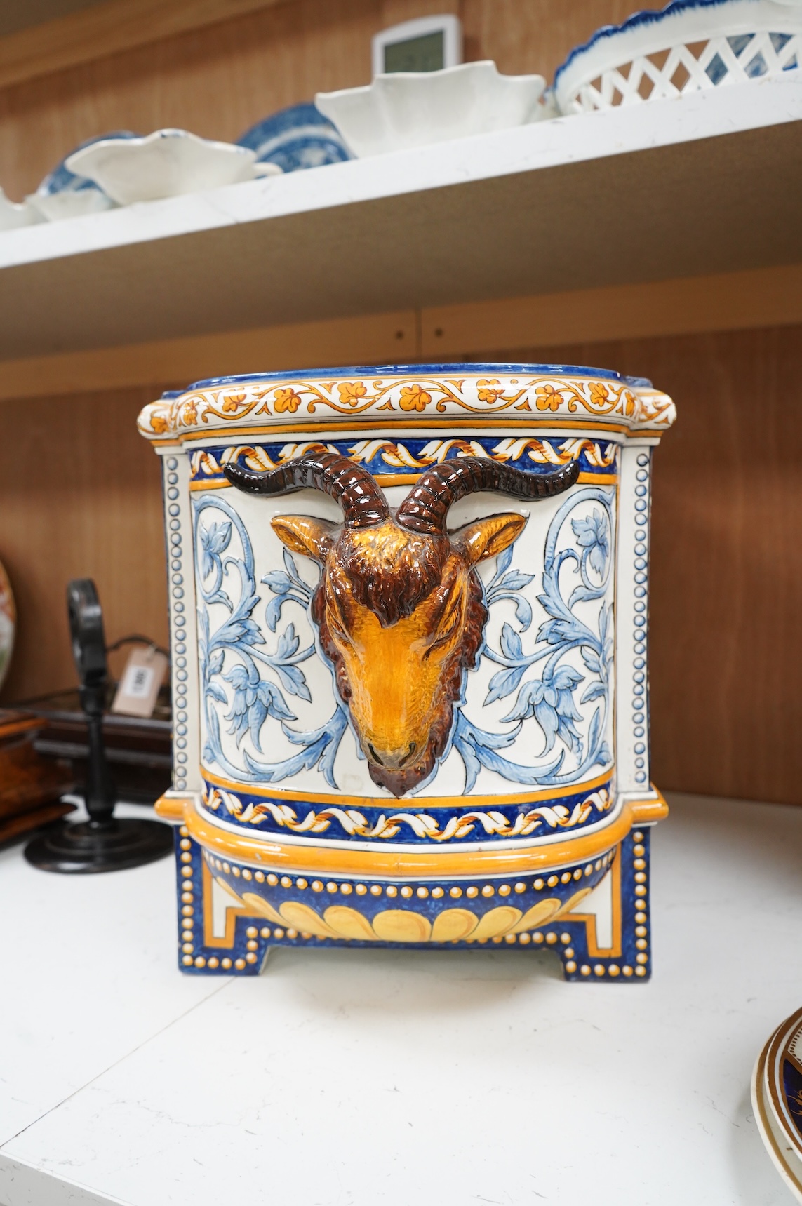 A large 19th century French faience wine cooler or planter with ram’s head handles, 60cm wide